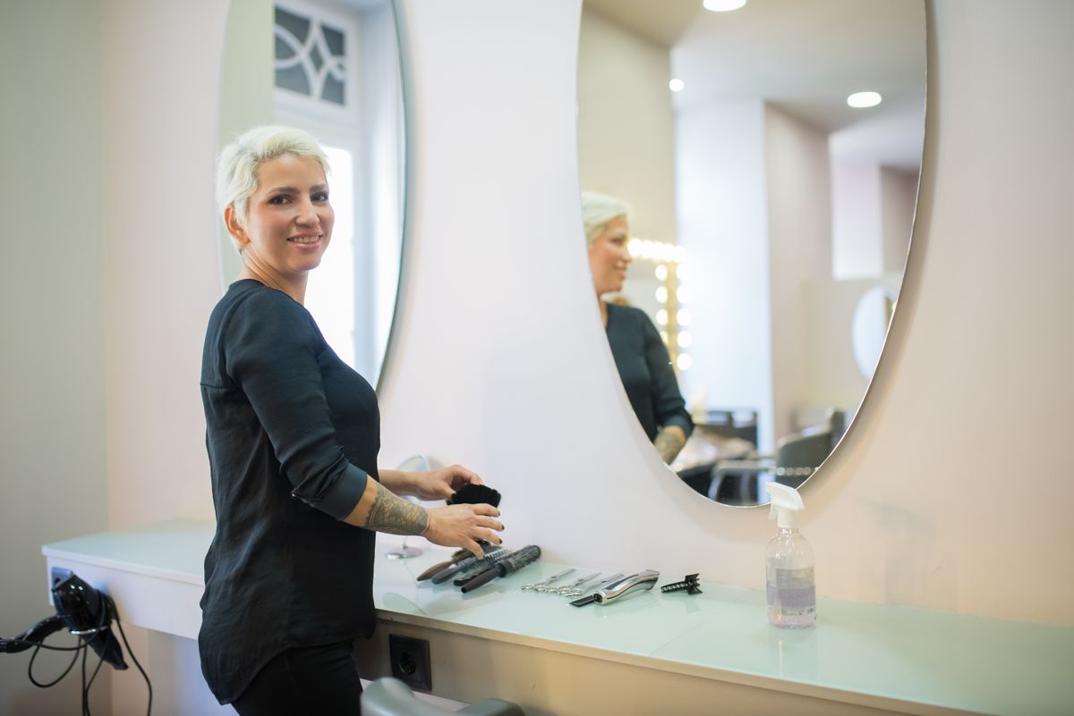 A stylist and client in a bright modern salon